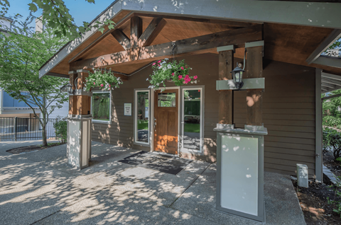 A shaded walkway leading up to the entrance of the renovated leasing office at Foster Creek apartments